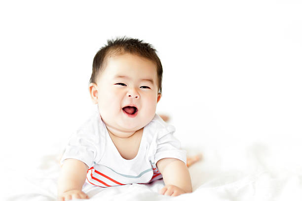 istock Sweet little baby girl crawling on white bed 472229607