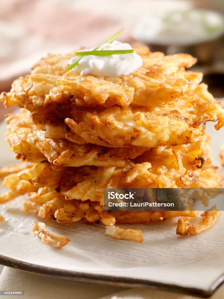 Potato Pancakes Potato Pancakes, Latkes with Sour Cream and Chives -Photographed on Hasselblad H1-22mb Camera Potato Pancake Stock Photo