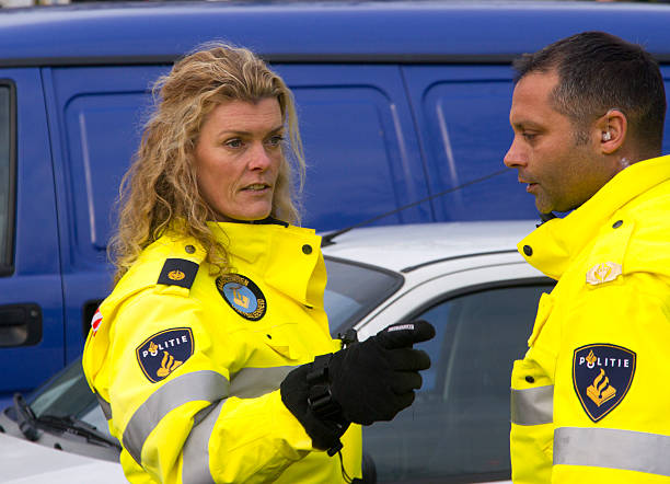 Female police officer The Hague, Holland - January 21, 2011: Female police officer talks to a colleague at a political demonstration on January 21, 2011 in The Hague, Holland riot police stock pictures, royalty-free photos & images