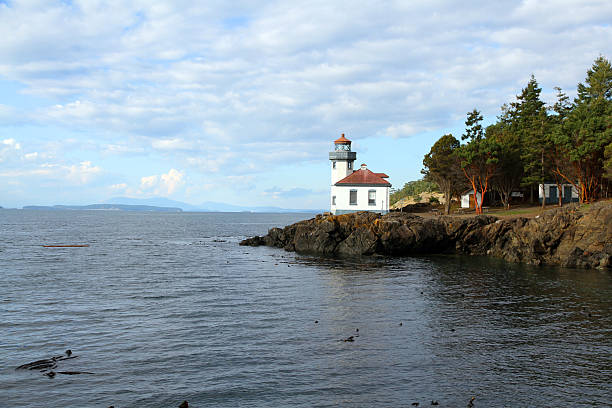 Spit of Land The Lime Kiln historic lighthouse on San Juan Island, in Washington State.   lime kiln lighthouse stock pictures, royalty-free photos & images