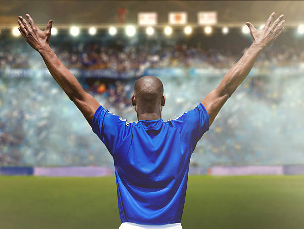 Happy football player at the stadium getting an ovation