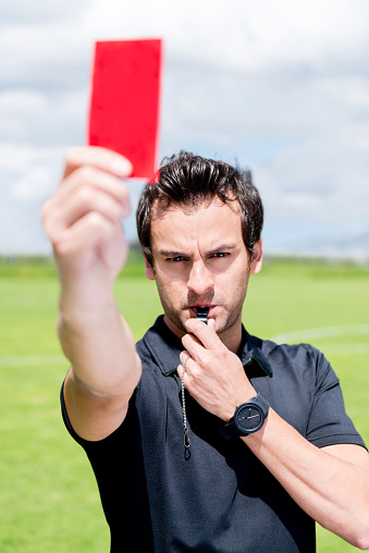Football referee giving a red card