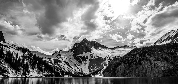 SnowMass Wide Mountains Snow Pack Cliffs and Lake Colorado Rugged Summits. Ice Packs , national forest , high altitude snowmass lake. The Storms came through and brought some amazing early summer storms. 