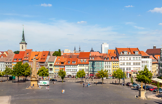 Erfurt, Germany - May 26, 2012: people enjoy visiting the famous market place at dome hill in Erfurt, Germany. The old house facades are restored in original style.