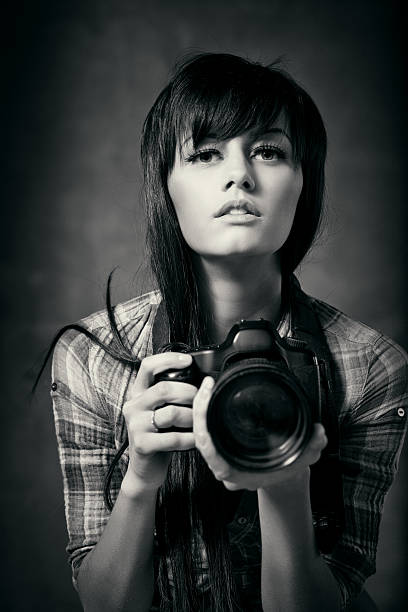 istock young woman photographer 472235097