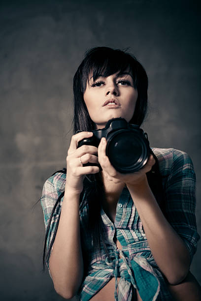 istock young woman photographer 472235107