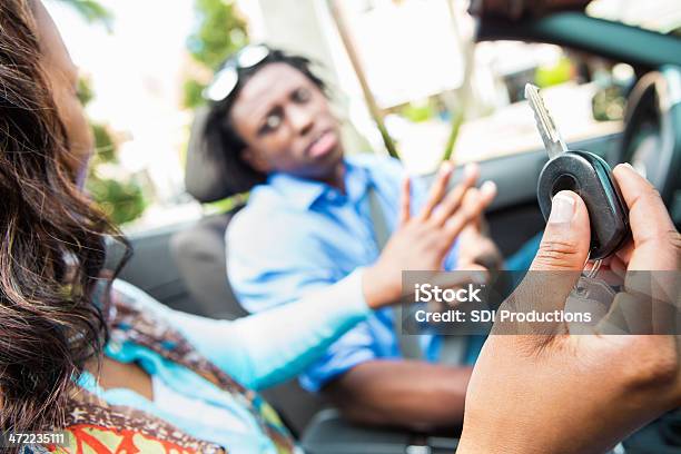 Woman Holding Back Car Key From Driver Stock Photo - Download Image Now - Car Key, Removing, Car