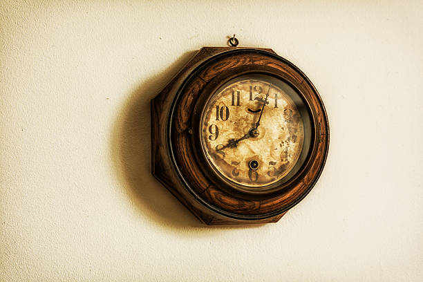 istock Antique Clock Hanging on Grungy Wall 472236177