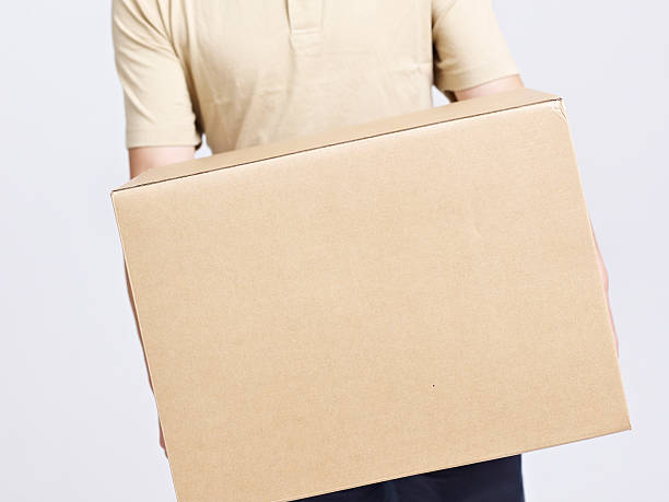 istock deliveryman or warehouseman carrying a large cardboard box 472237440