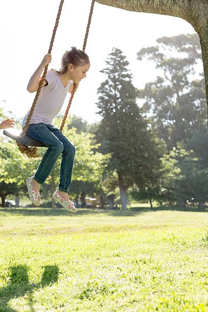 istock Girl swinging in park 472237745