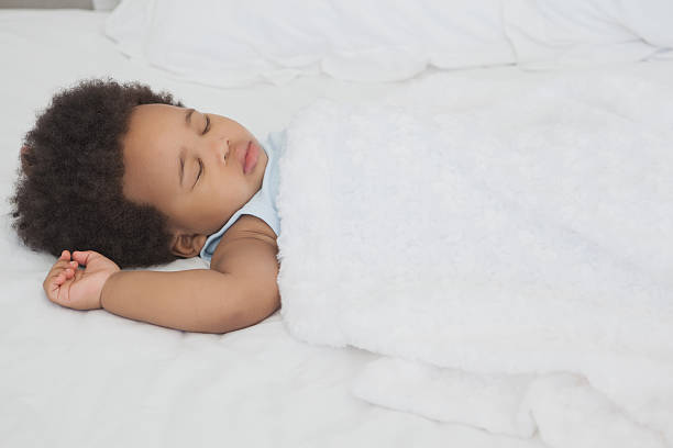 istock Cute little Afro baby sleeping in bed 472237893