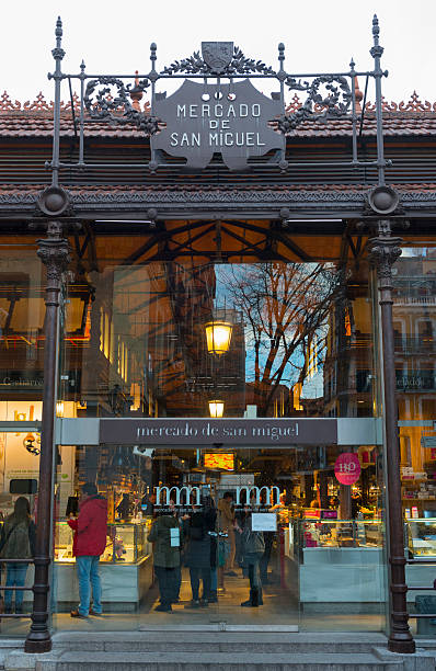 Madrid, Spain - January 26, 2014: Iron entrance to the Market of San Miguel in Madrid, Spain. Declared Bien de Interés Cultural in the year 2000, the building preserves its original iron structure from the beginning on the XX Century. It is located in the square of the same name, within walking distance from the Plaza Mayor.