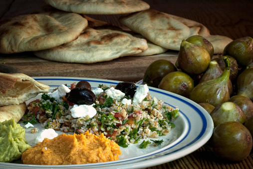 A hand made meal of Mediterranean delicacies, including homemade pita and figs.