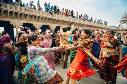 Barsana, India - March 10, 2014: Teenage Indian girls celebrate Holi dancing in Radha Rani Temple in Barsana Village.