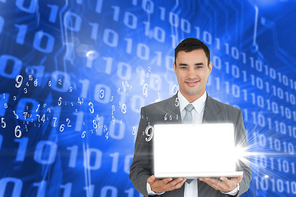 istock Handsome businessman showing laptop with numbers 472239319