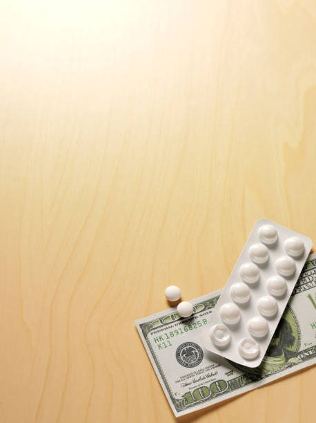 istock 100 Dollars with Prescription Tablets 472239491