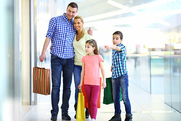 istock Young family in shopping mall. 472240861