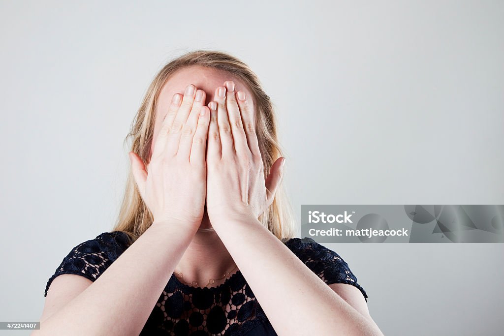 Woman hiding her face Adult Stock Photo