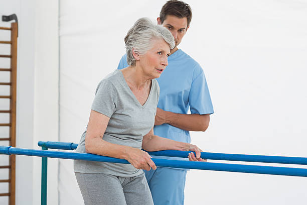 istock Determined senior woman walking on parallel bars 472242373