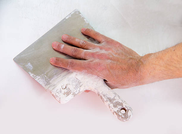 istock Plastering wall with plaste and plaster spatula trowel 472242608