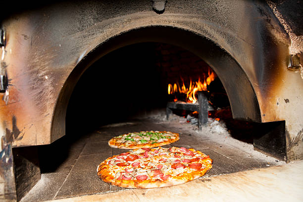 istock Pizza in a Wood Burning oven 472242944