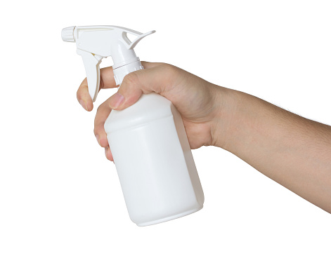 hand holding a spray bottle isolated on white