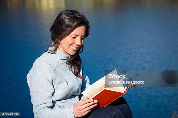 Young Woman Reading Book Stock Photo - Download Image Now - 2015, Adult, Adults Only