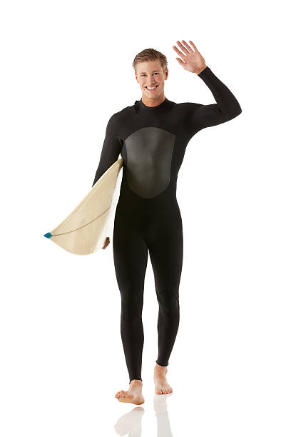 istock Male surfer holding surfboard and waving hand 472251086
