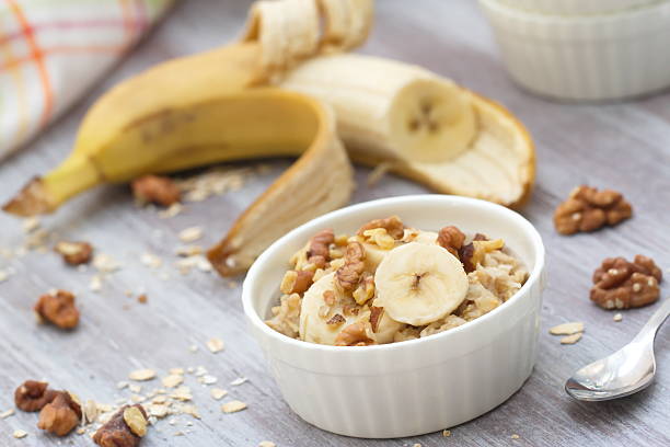 istock Oatmeal with banana, honey and walnuts for breakfast 472251424