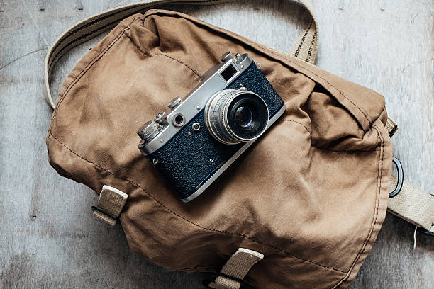 istock Old camera in bag, vintage photo grunge design component 472252050