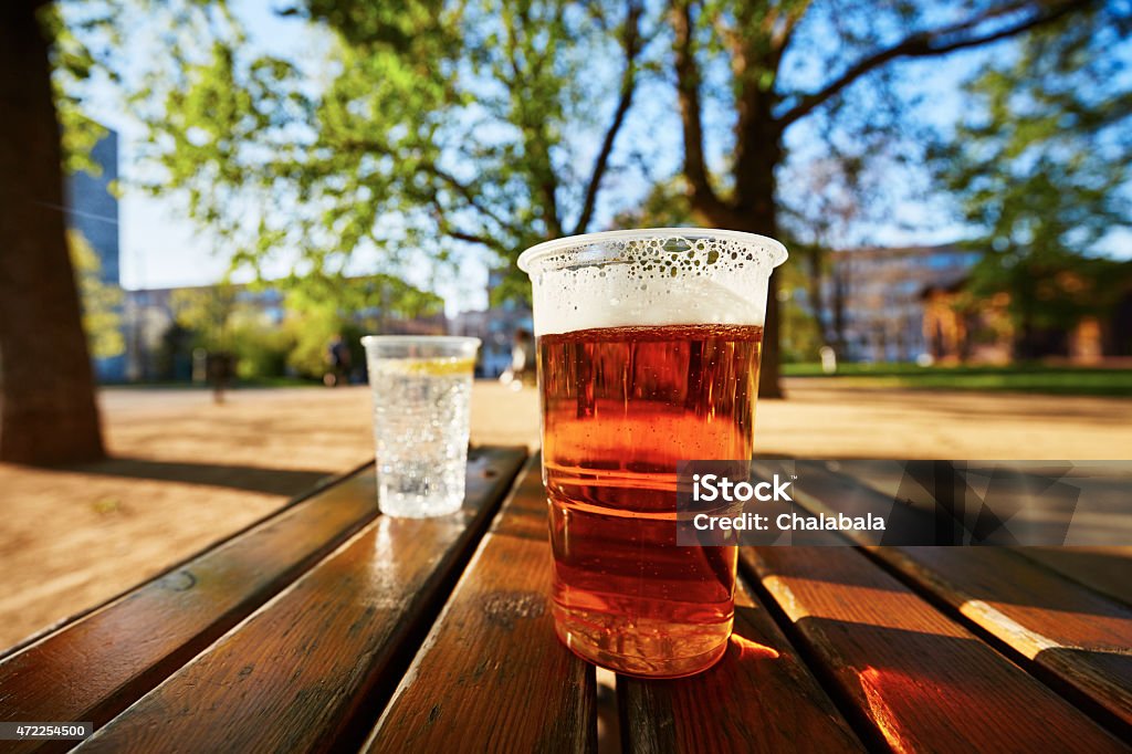Refreshment in the garden Cups of beer and water in the garden restaurant Beer Garden Stock Photo