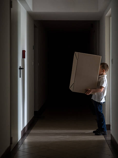 Delivery boy holding a package stock photo