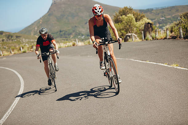 istock Cyclists cruising and burning rubber on the open road  472257832
