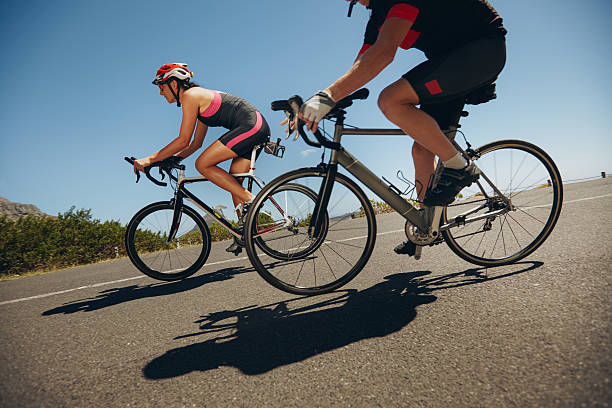 istock Cyclist riding bicycles down hill on country road 472257856