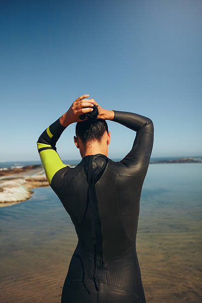 istock Female triathlon athlete getting ready for the competition 472258056