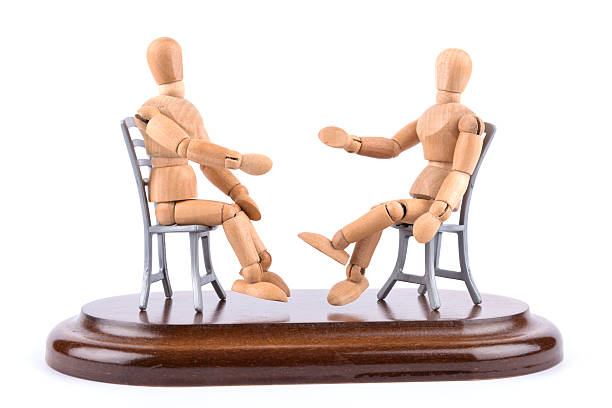 istock wooden mannequin talking together on chairs - mediation 472258530