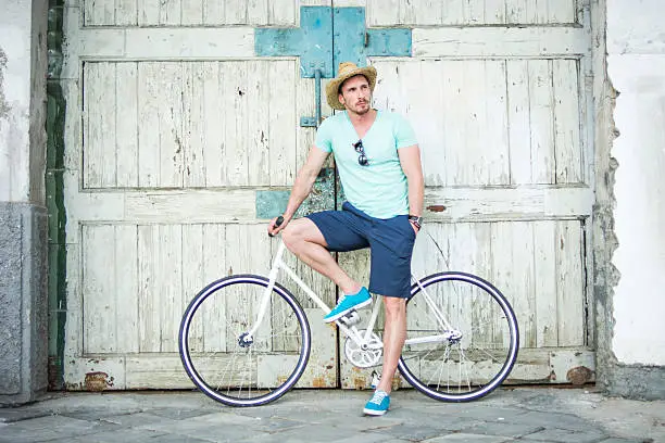 Photo of Man posing with bicycle