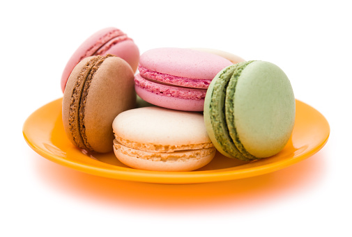 colorful macaroons on plate with clipping path, side view