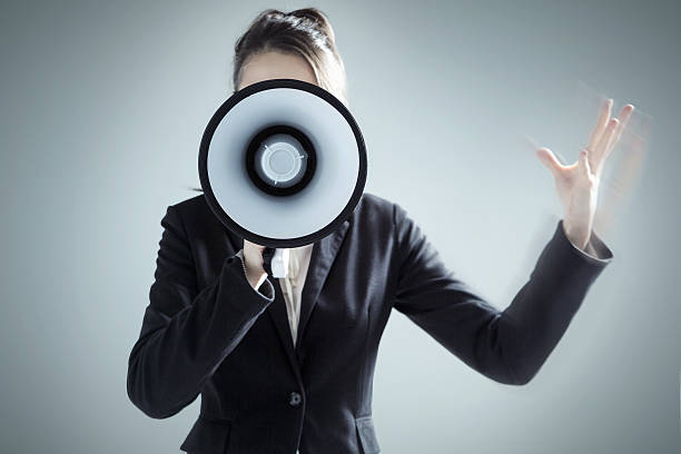 istock Young businesswoman yelling over megaphone 472266478