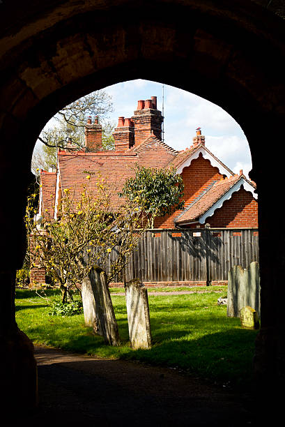 istock Churchyard through an arch, East Bergholt, Suffolk 472268976