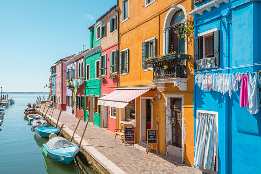 Venice landmark, Burano island canal, colorful houses and boats, Italy, Europe