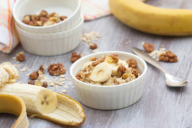 istock Oatmeal with banana, honey and walnuts for breakfast 472277052