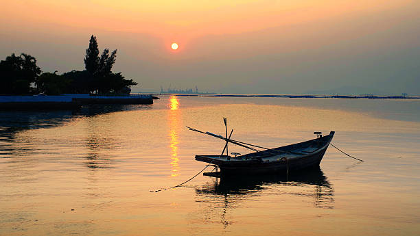 istock Fisherman boat floating with sunset bacgkround 472277158