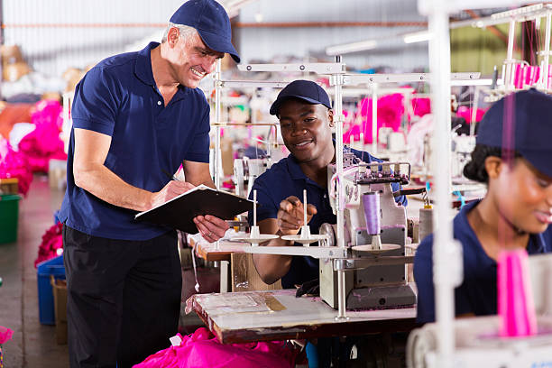 istock senior supervisor taking score from machinist 472278130