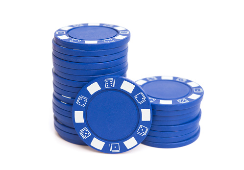 two stacks of blue poker chips on white with clipping path