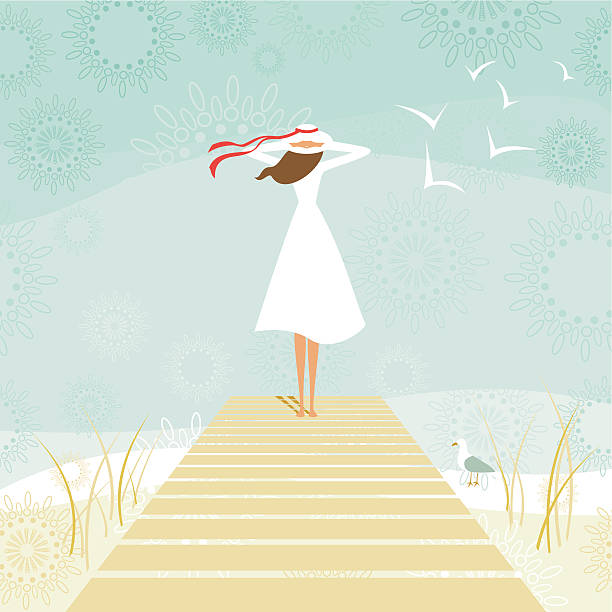 Woman standing on a wooden pier while contemplating the sea.