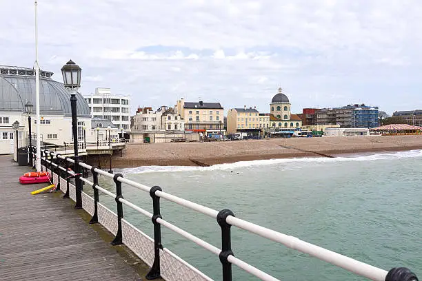 A view towards the town and beach from the pier at Worthing, East Sussex, UK