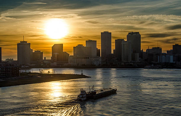 Sunset over New Orleans Sunset over New Orleans, Louisiana from a cruise ship. mississippi delta stock pictures, royalty-free photos & images