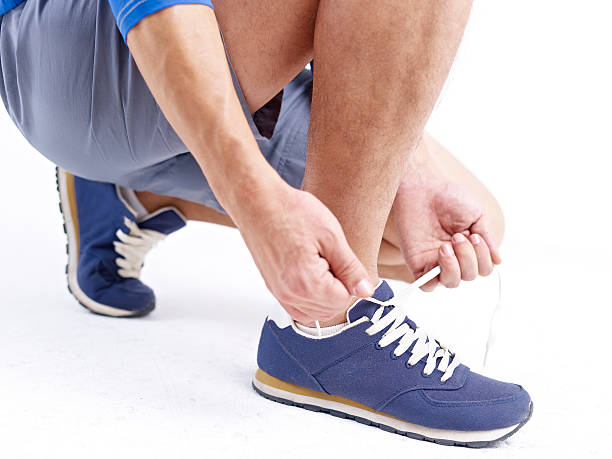 istock male athlete tying up shoelace ready for exercise 472290432