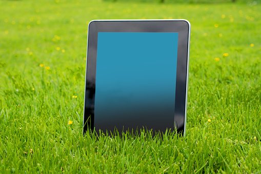 Tablet in the grass ready for your copy